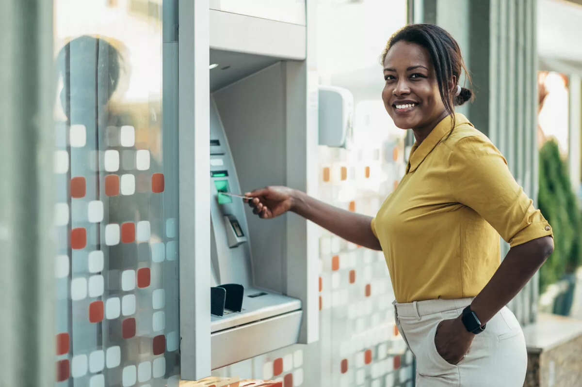 African american woman using an atm machine and a 2025 04 01 13 22 48 utc